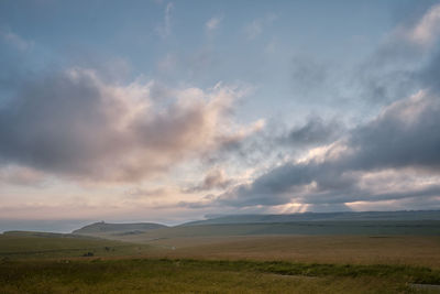 Scenic view of field against sky during sunset