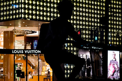 People standing in illuminated restaurant