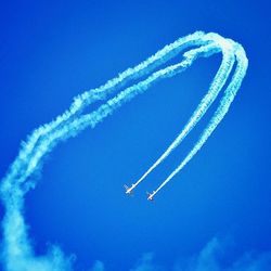 Low angle view of helicopter flying in sky