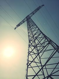 Low angle view of electricity pylon against sky