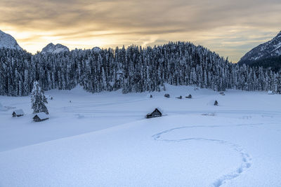Scenic view of snow covered field against sky