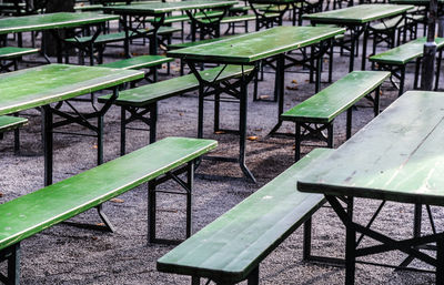 Empty chairs and tables at sidewalk cafe