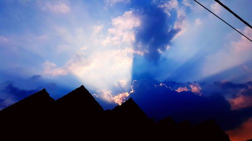 Low angle view of buildings against cloudy sky