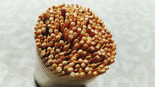 High angle view of toothpicks in container on table