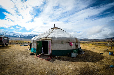 Built structure on field against sky