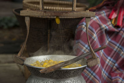 Silkworm cocoons boiling in container