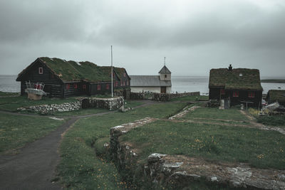 Houses on field against sky