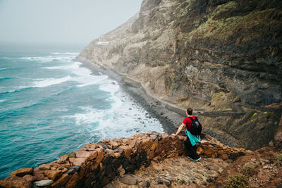 Rear view of man looking at sea shore