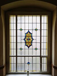 Multi colored glass window hanging on ceiling