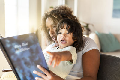 Mother and daughter using mobile phone