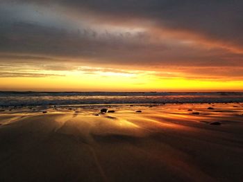 Scenic view of beach against sky during sunset