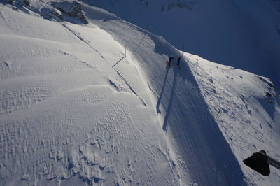 High angle view of people skiing on snowcapped mountain