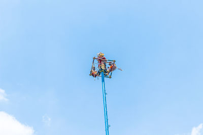 Low angle view of crane against sky