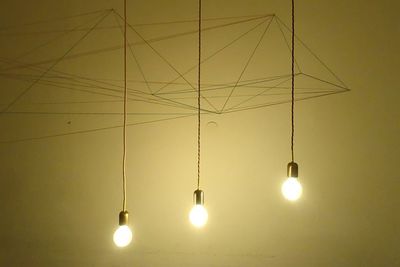 Low angle view of illuminated electric lamp