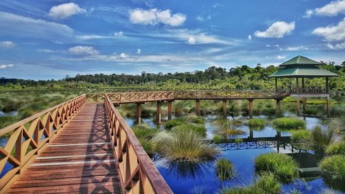 Bridge over lake against sky