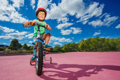 Low angle view of man riding bicycle on street