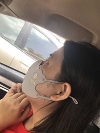 Portrait of woman holding hands while sitting in bus
