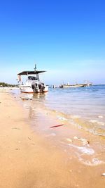 Scenic view of sea against clear blue sky