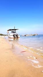 Scenic view of sea against clear blue sky