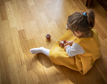 High angle view of girl holding toy at home