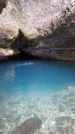 Scenic view of rocks in water against sky