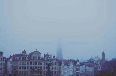 High angle view of buildings in city against sky during foggy weather