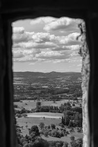 High angle view of townscape against sky seen through window