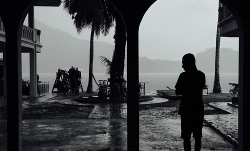 Rear view of woman standing in water