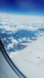 Aerial view of aircraft wing against sky