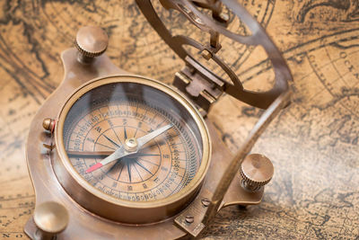 Close-up of navigational compass on map