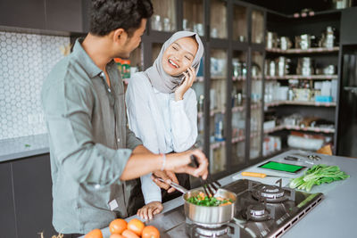 Portrait of woman holding food at restaurant