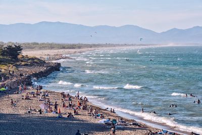 People on beach against sky