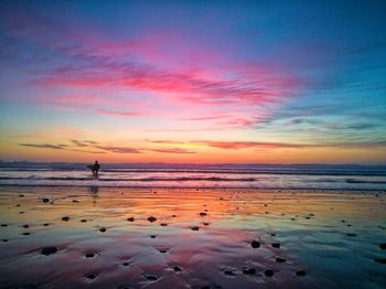 Scenic view of beach against sky during sunset