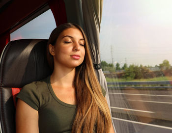 Beautiful young woman sleeping in train