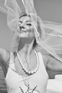 Close-up of smiling woman holding veil