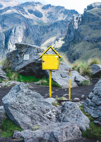 Yellow manmade objects in nature amongst rocky mountains