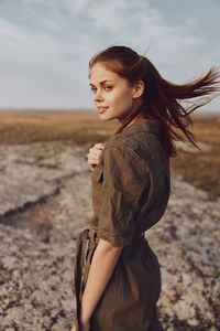 Young woman standing at beach