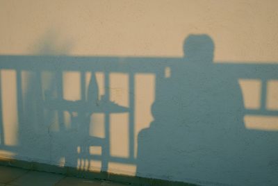 Shadow of man on tiled floor