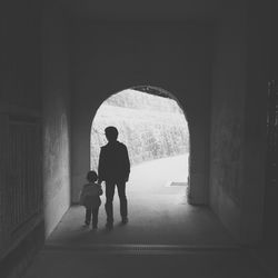 Rear view of people walking on corridor