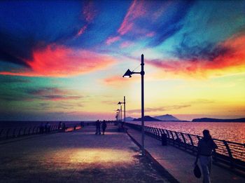 Scenic view of sea against cloudy sky at sunset