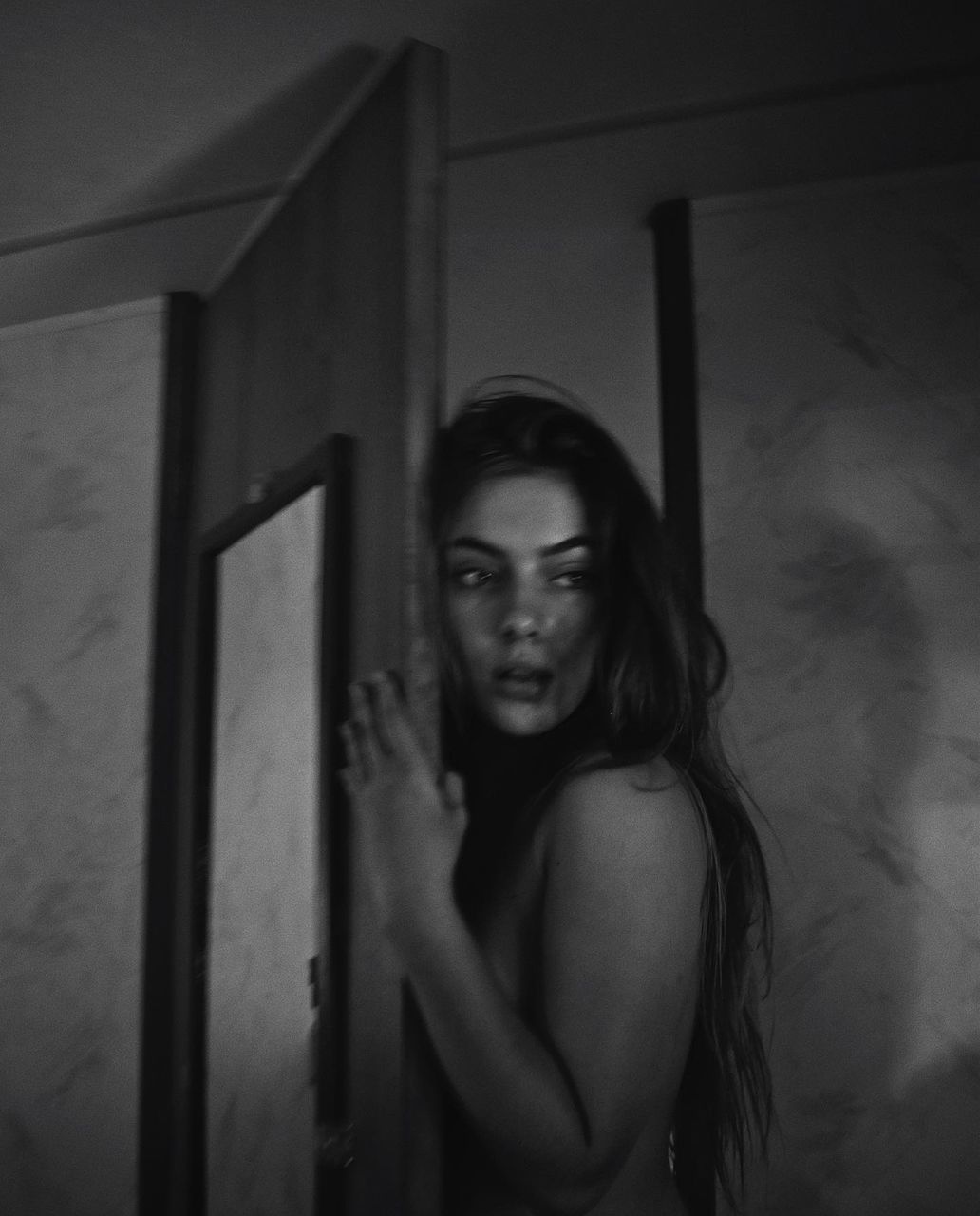 one person, black, portrait, black and white, looking at camera, white, darkness, adult, young adult, women, indoors, fear, monochrome photography, dark, monochrome, standing, hairstyle, long hair, door, spooky, emotion, waist up, horror, entrance, loneliness