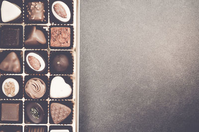 Directly above shot of various chocolates in box on table