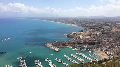 High angle view of sea and city against sky