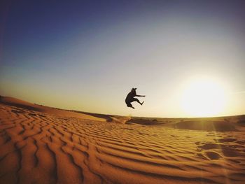 Man jumping in desert