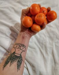 Cropped hand of man holding fruits