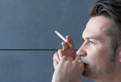 Portrait of man smoking cigarette