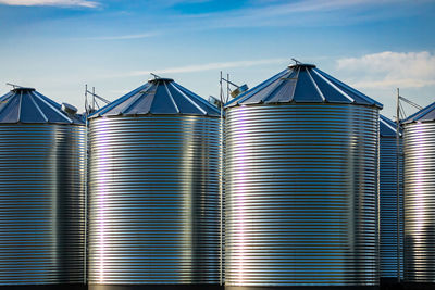 Low angle view of industry against sky