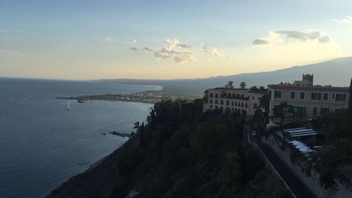 High angle view of buildings by sea against sky