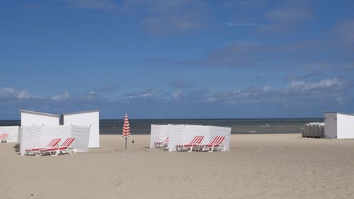 Lifeguard hut on beach against sky