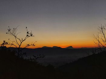 Scenic view of silhouette mountain against sky at sunset